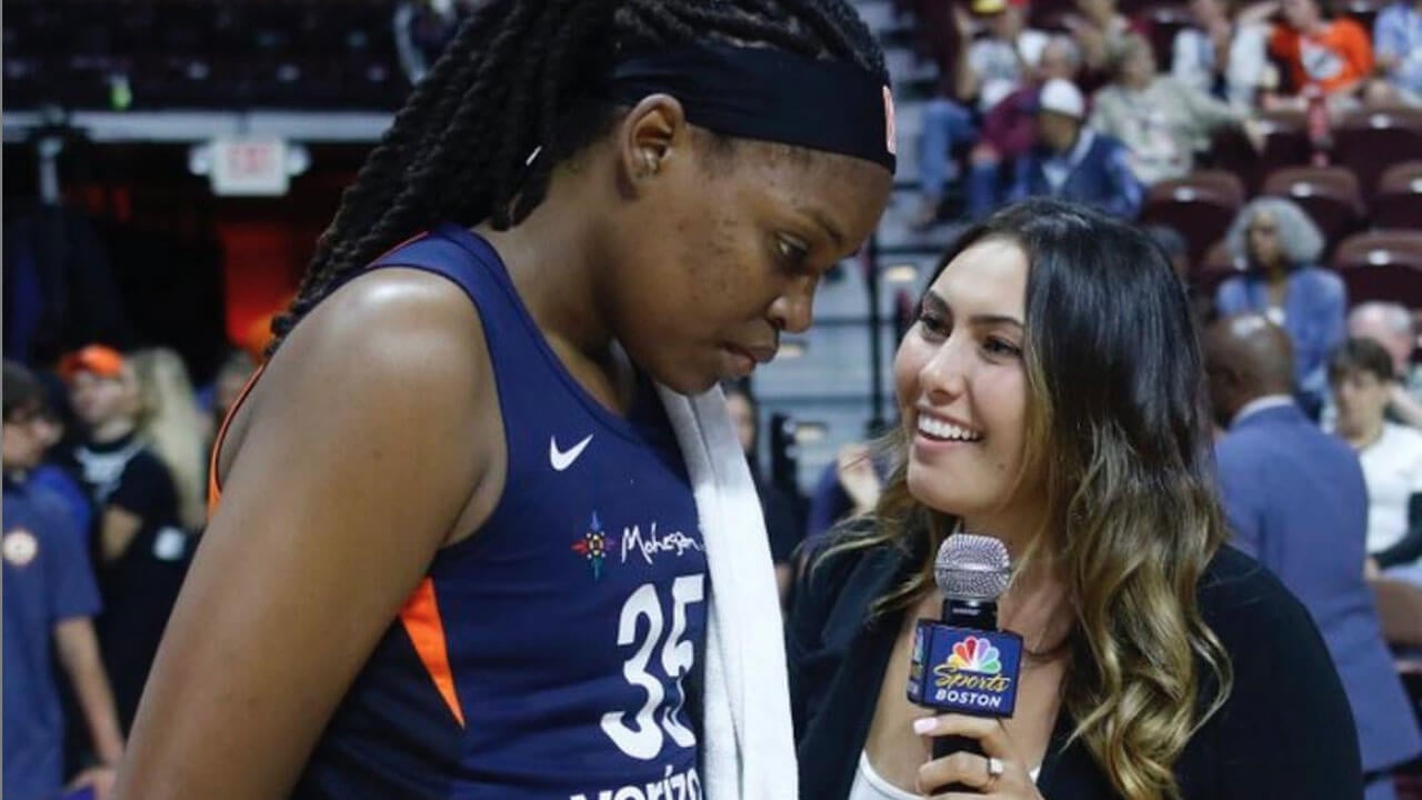 Robyn Brown interviewing a WNBA player on the court