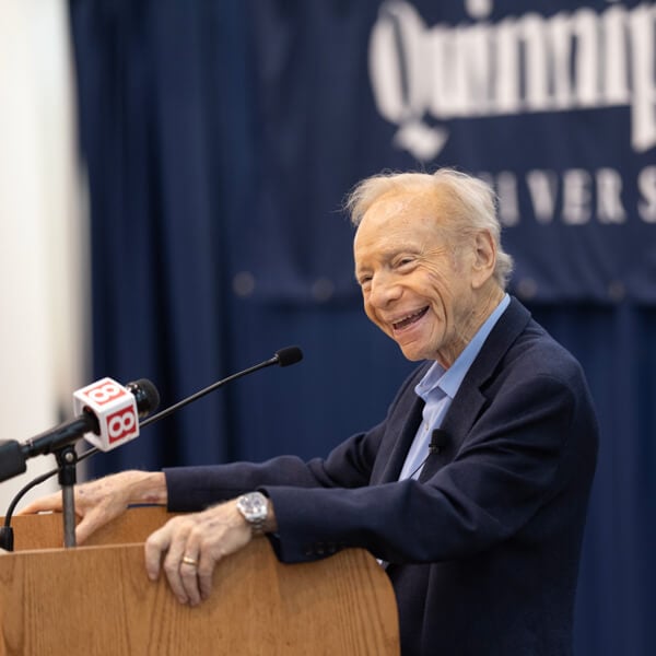 Former U.S. Senator Joseph Lieberman speaks at a Quinnipiac podium