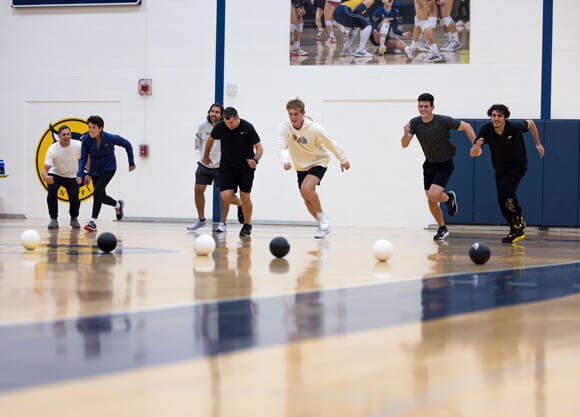 Students run to pick up dodgeballs