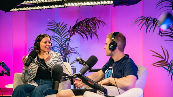 Two Quinnipiac students converse on a podcast set in Los Angeles.