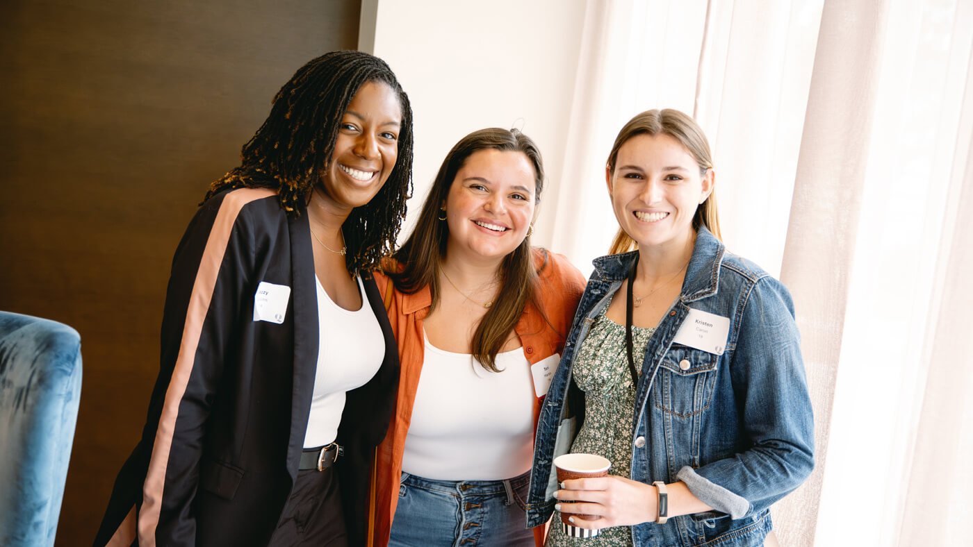 Quinnipiac University School of Communications alumni pose for a photo together.