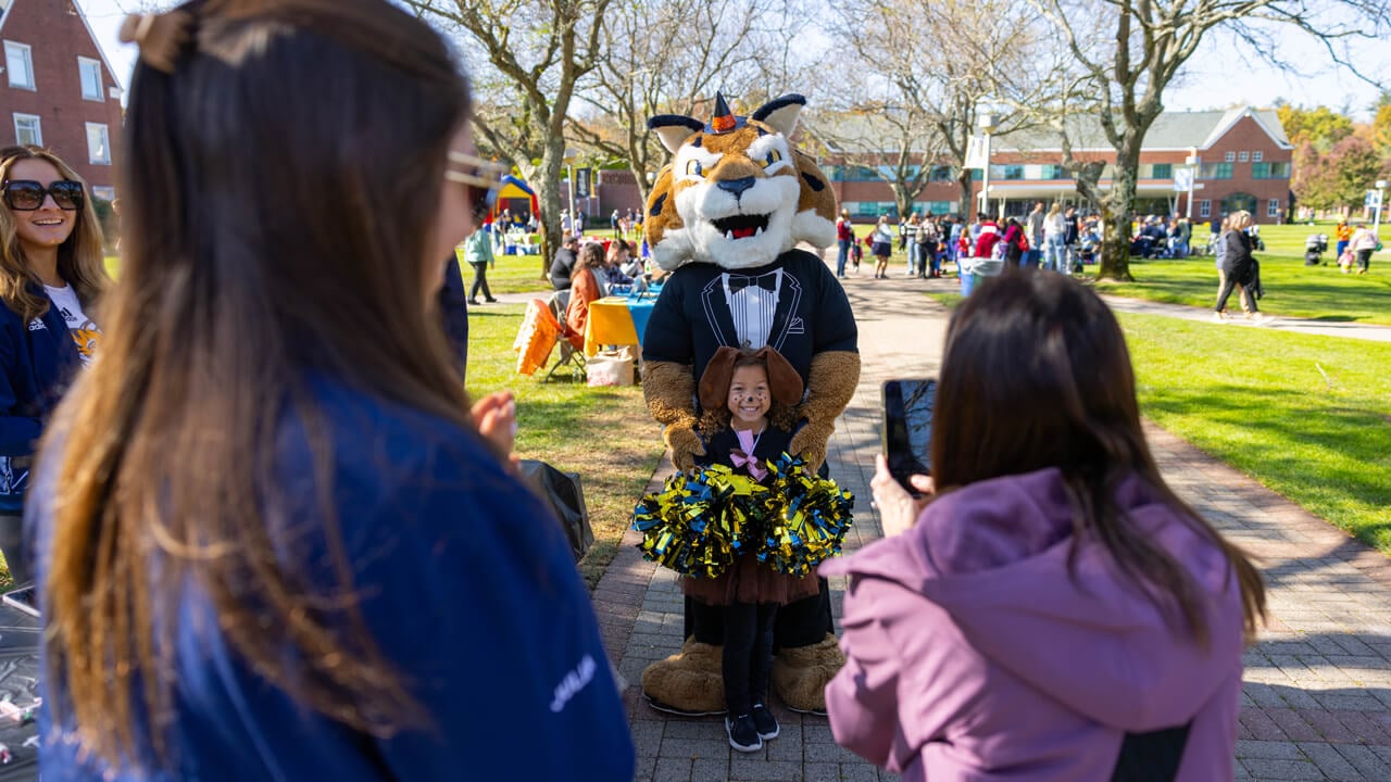 Boomer the mascot poses with a person