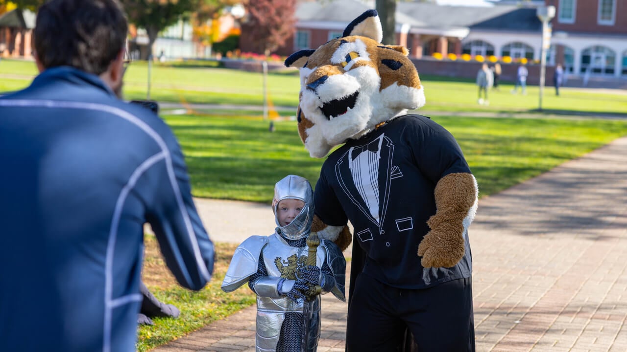 Boomer the mascot poses with a person