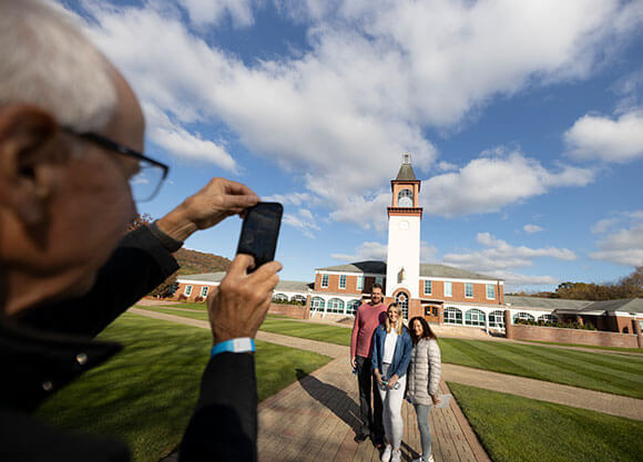 Family takes picture in front of the clocktower