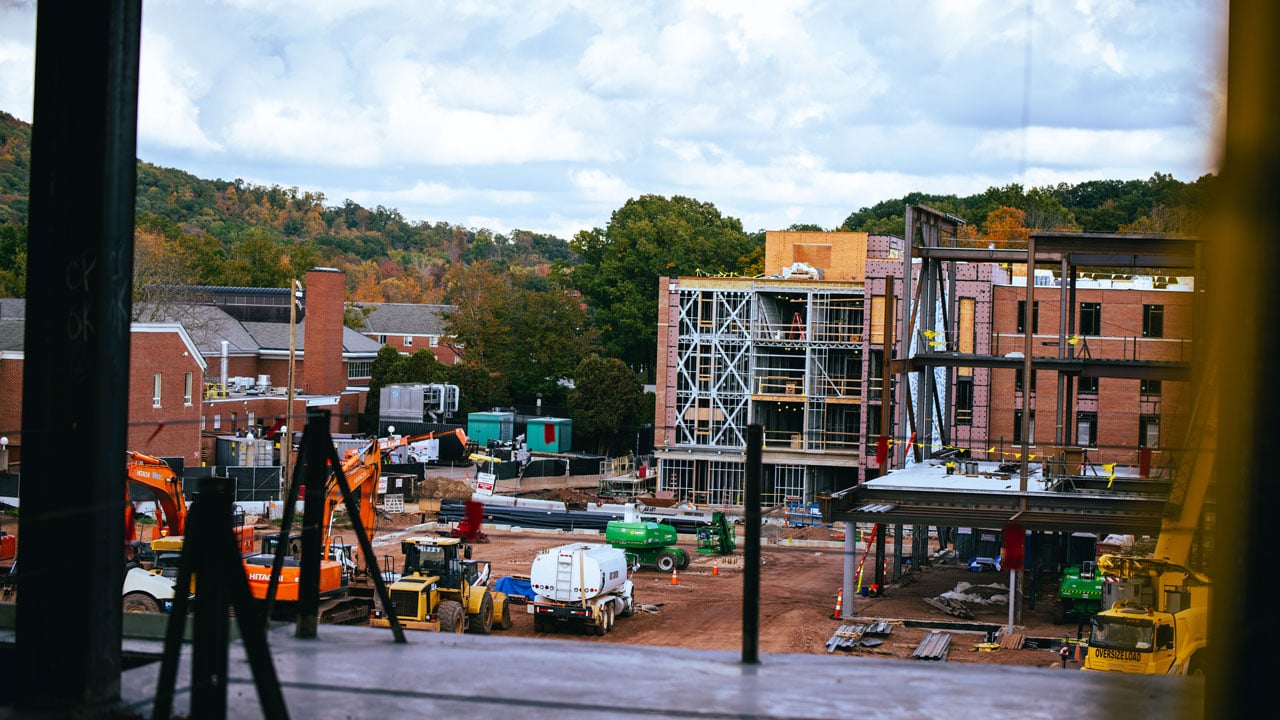 Construction vehicles and parts of buildings on the south quad construction site.