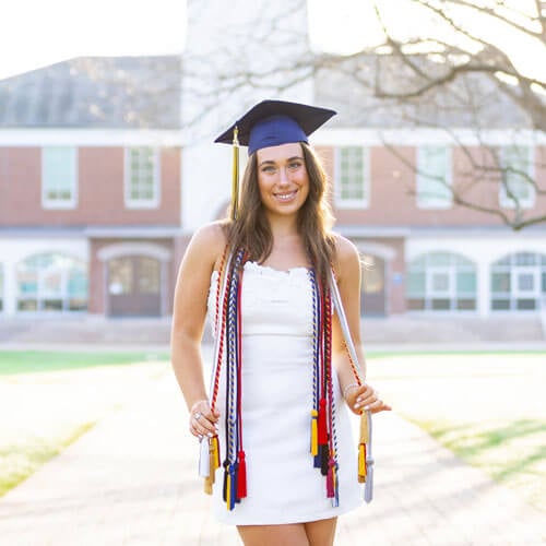 Madison Fahlborg stands in front of clocktower