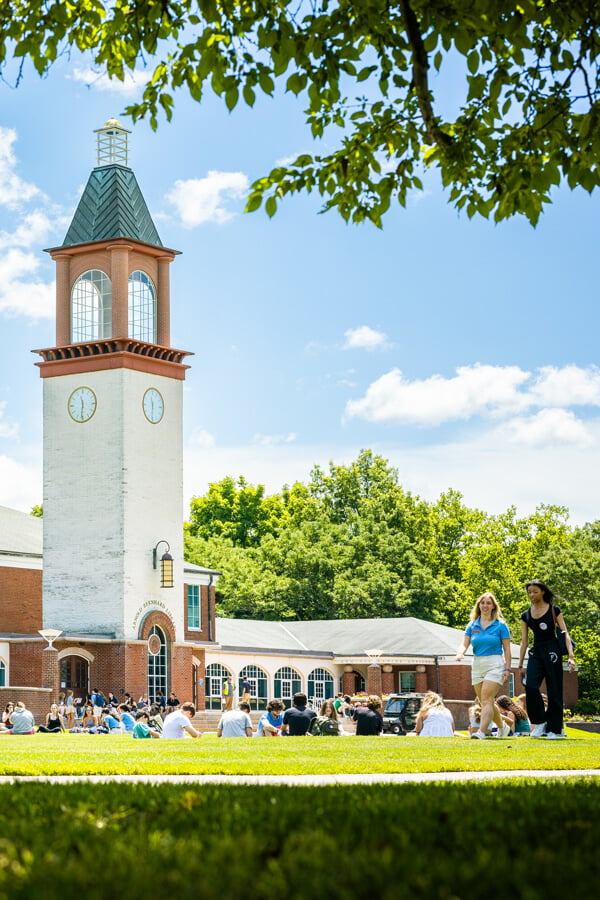 Several orientation groups sit on the quad by the Quinnipiac library on a sunny summer day