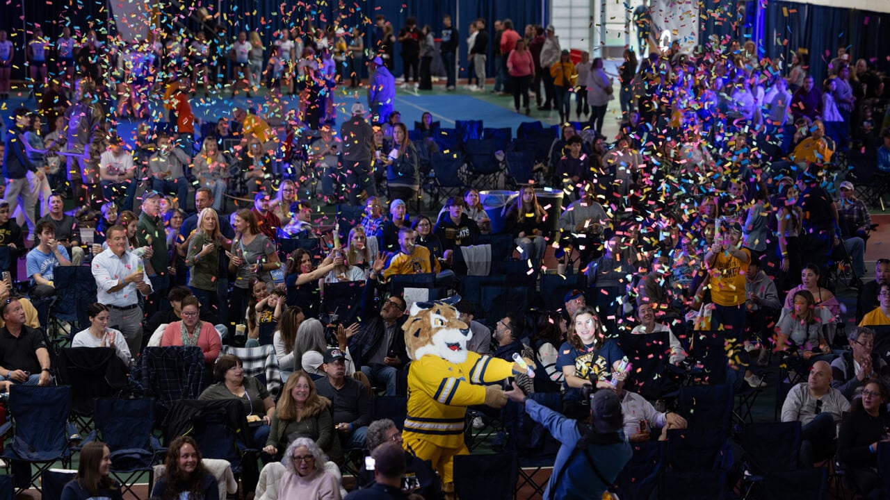 Aerial photo of the crowd and confetti falling at the men’s ice hockey Game Watch Party in the Recreation and Wellness Center.