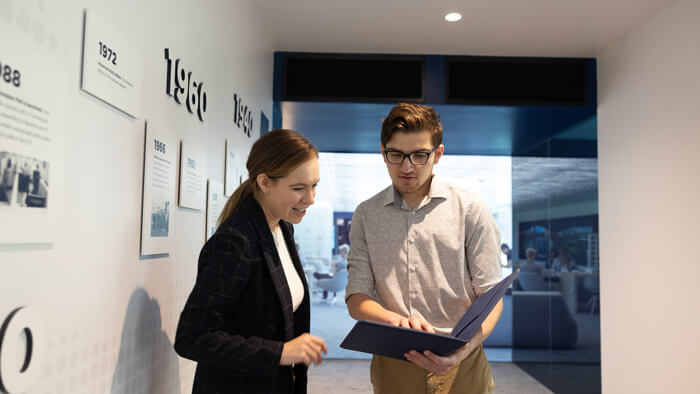 A student has a conversation with a faculty member in the Echlin Center.