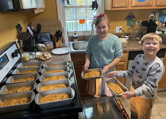 Emmet and Lilian baking pumpkin bread in the kitchen