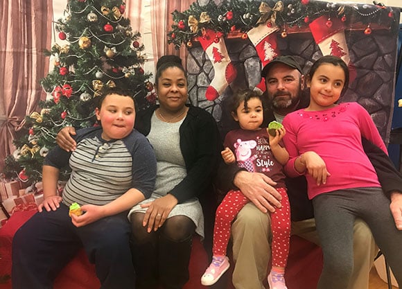 Scott family in front of Christmas decorations