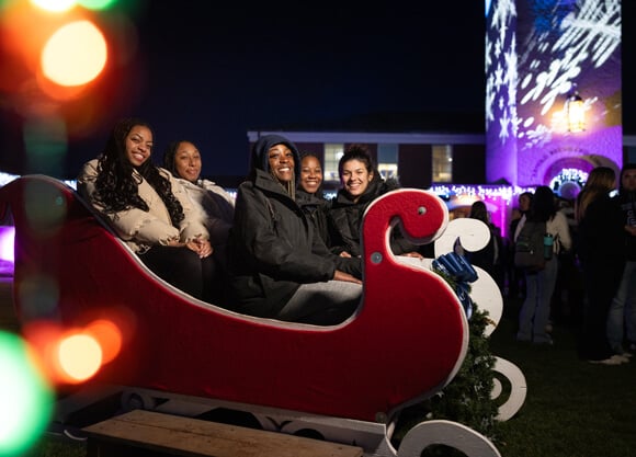 People sit in a sleigh on the Quad