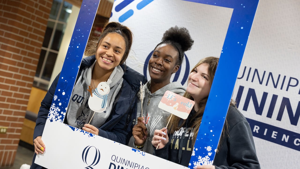 Individuals pose for a photo at the photo booth