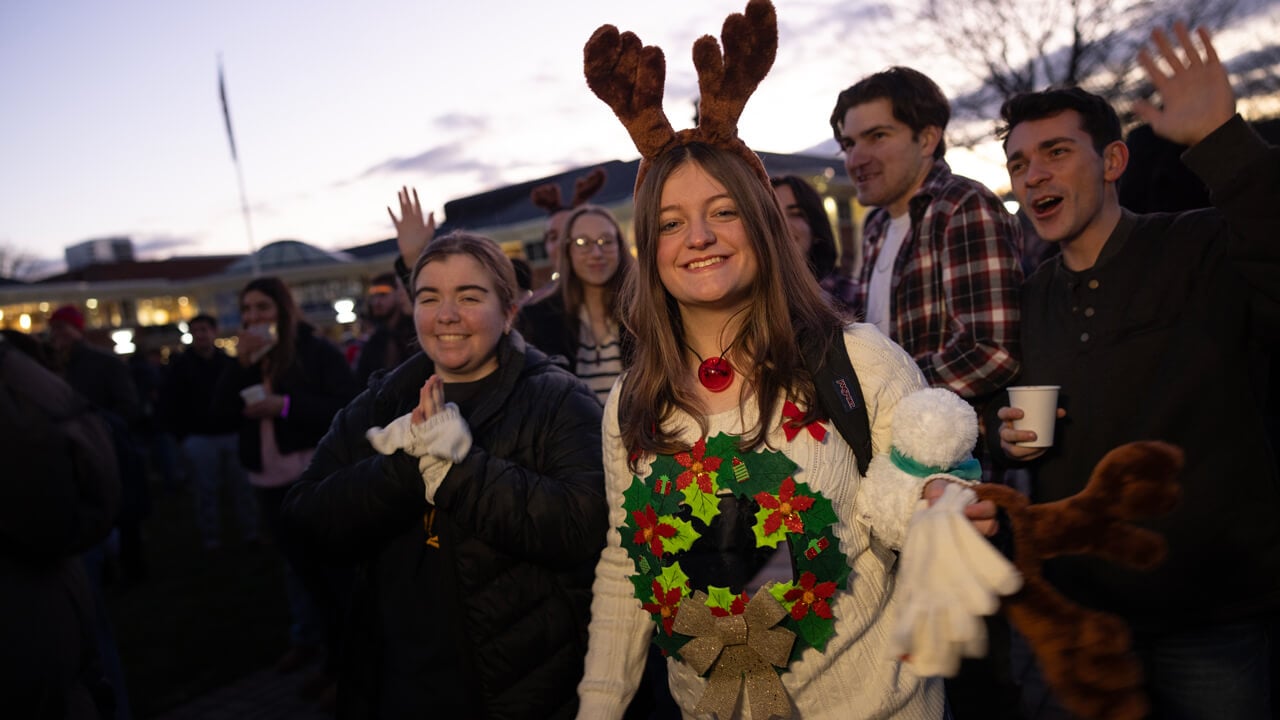 Person wears a holiday themed sweater