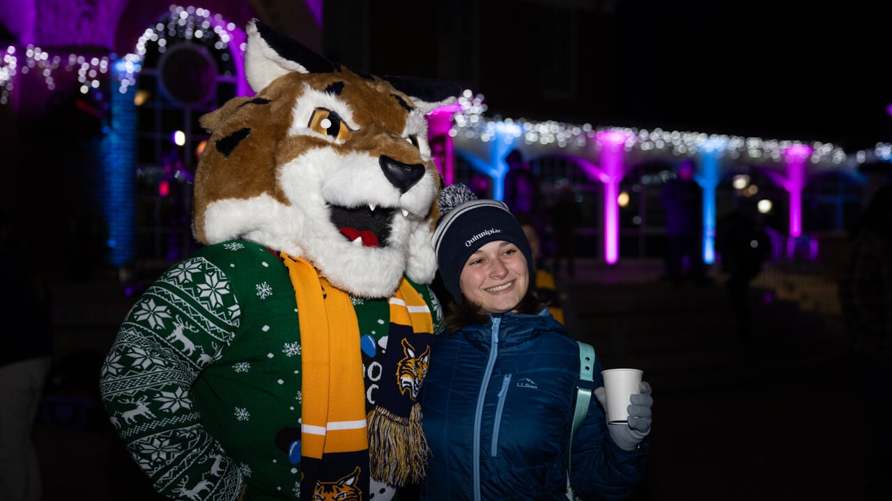 Boomer the mascot poses for a photo with an individual