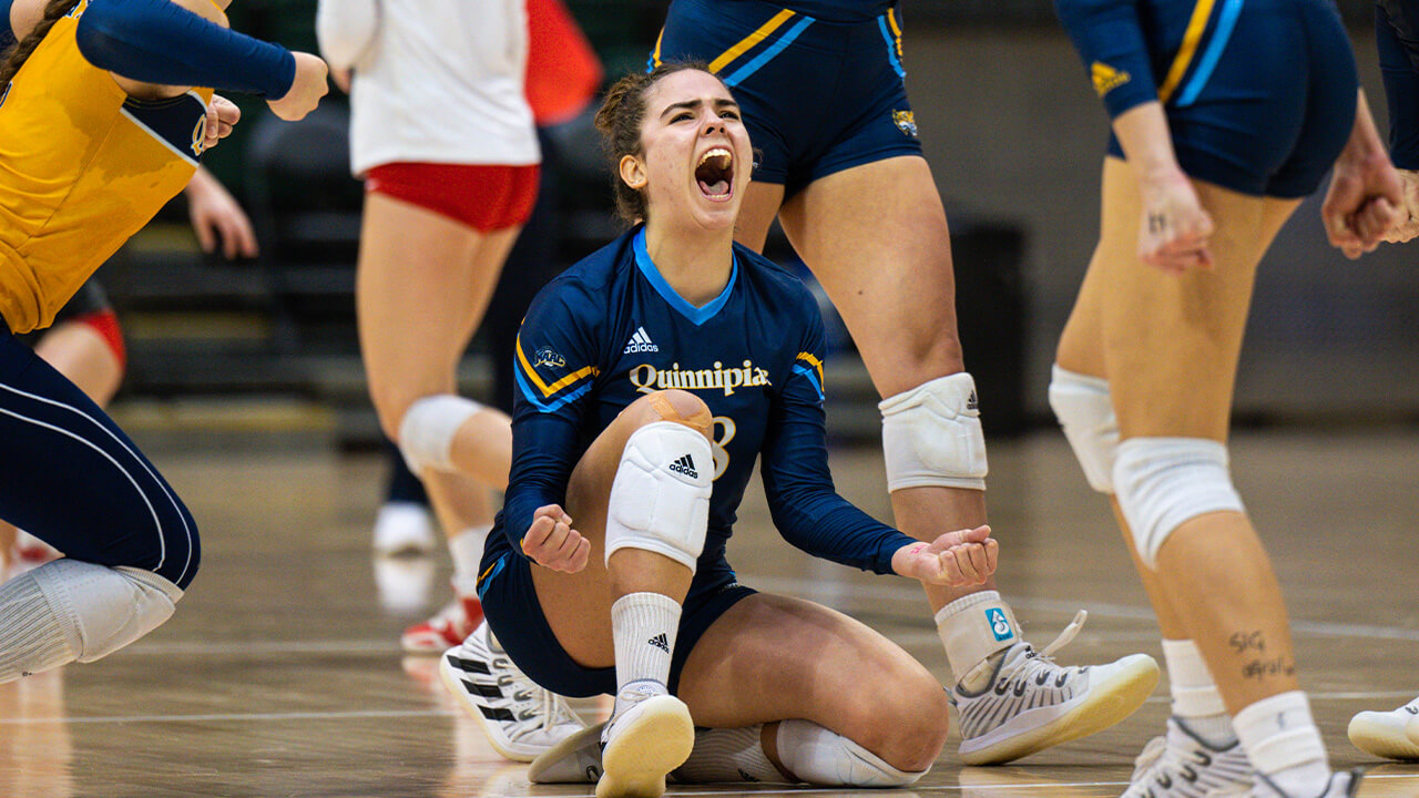 Damla Gunes crouching in excitement, celebrates wining a point.