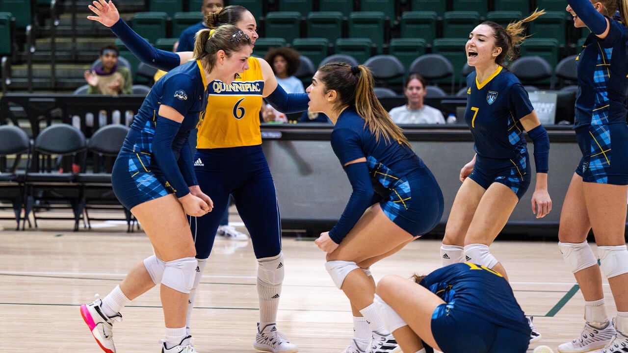 Players on the court scream in excitement after scoring a point.