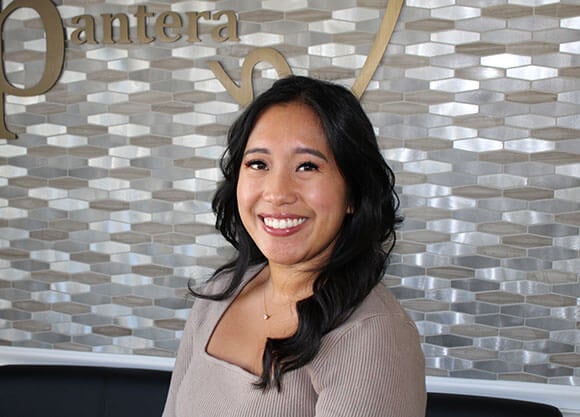 Gabriella Galvez smiling in front of a stone background