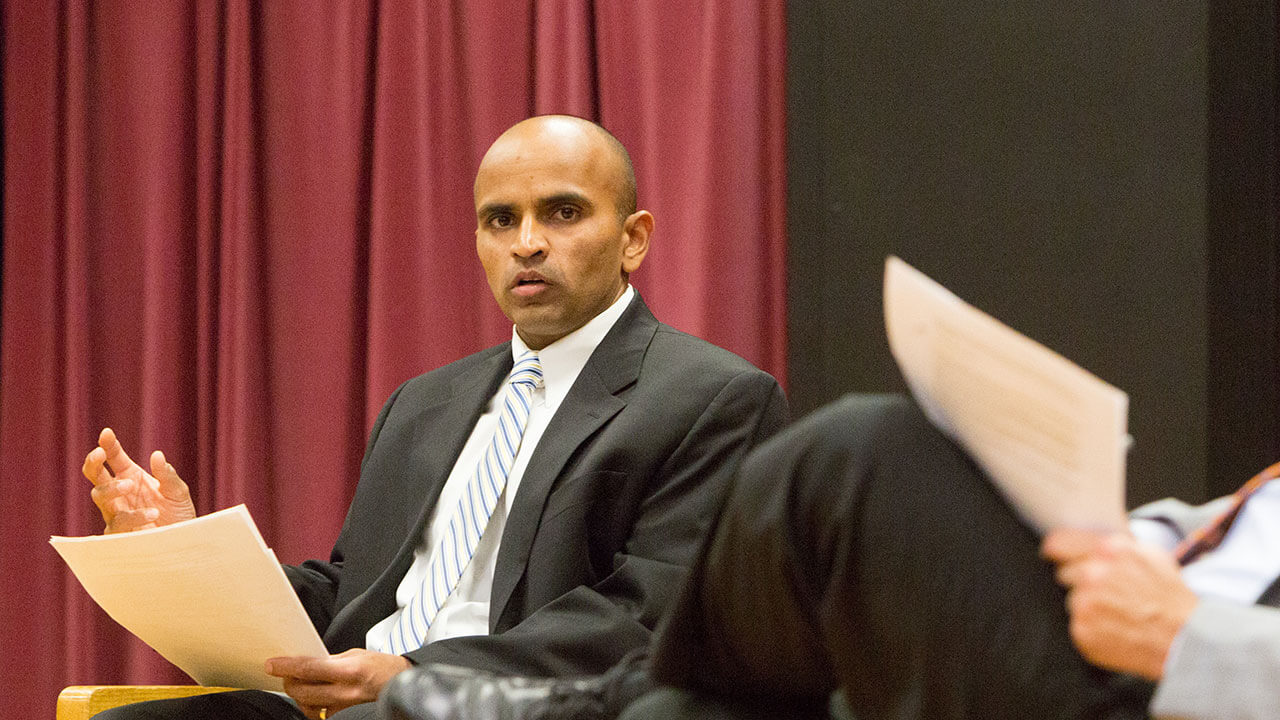 Brijesh Patel speaking at a conference.