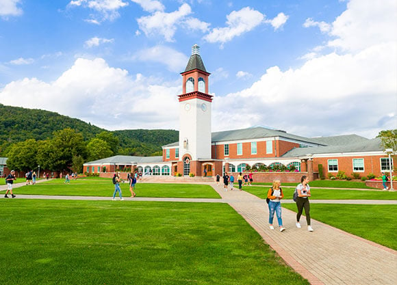 students walking outside in a campus courtyard