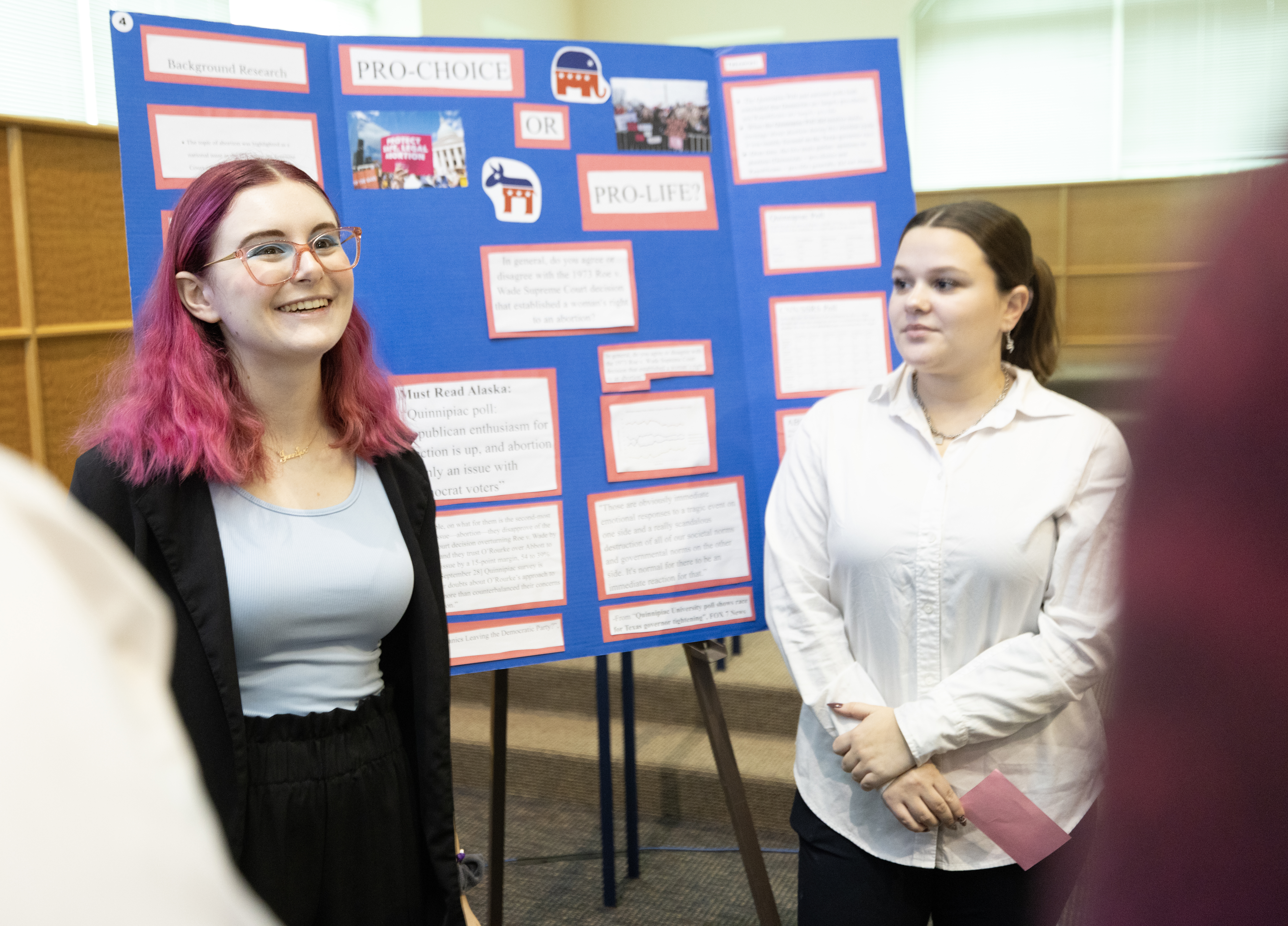 Students show off their posters