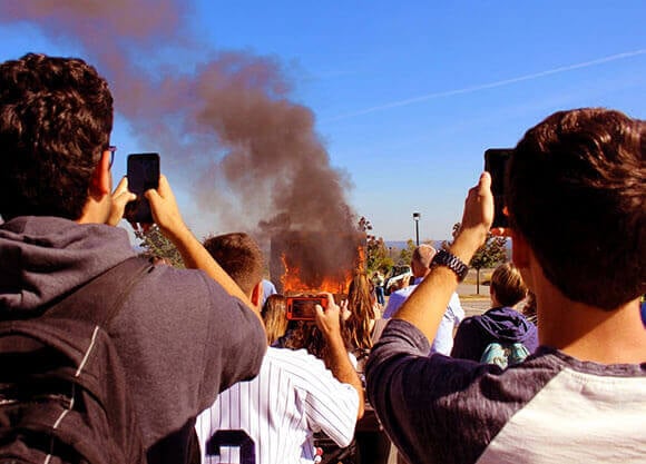 Quinnipiac students look on as the simulated residence catches fire, reaching temperatures between 800 and 1,000 degrees Fahrenheit.