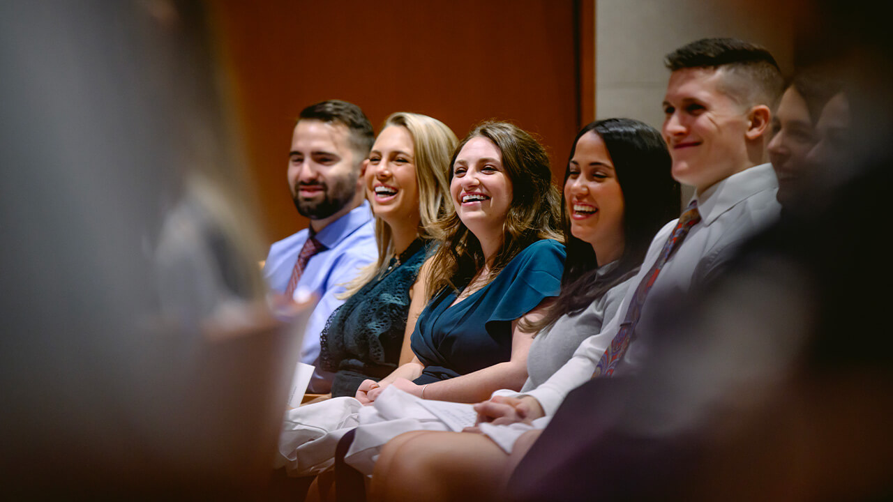 Students in the audience smiling, laughing.