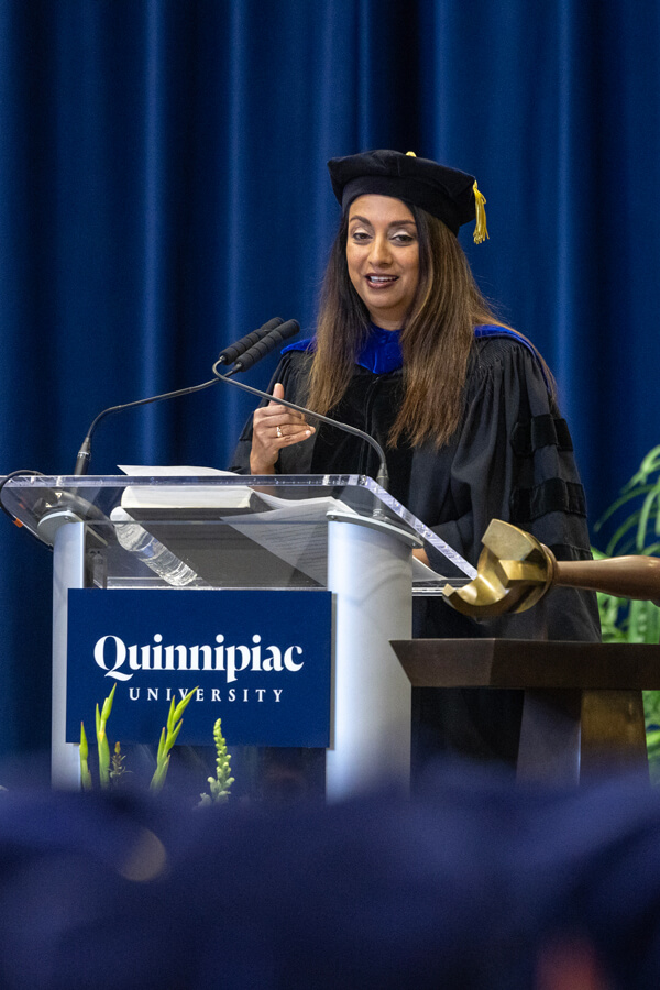 Manisha Juthani speaks from the Commencement podium to dozens of medicine graduates