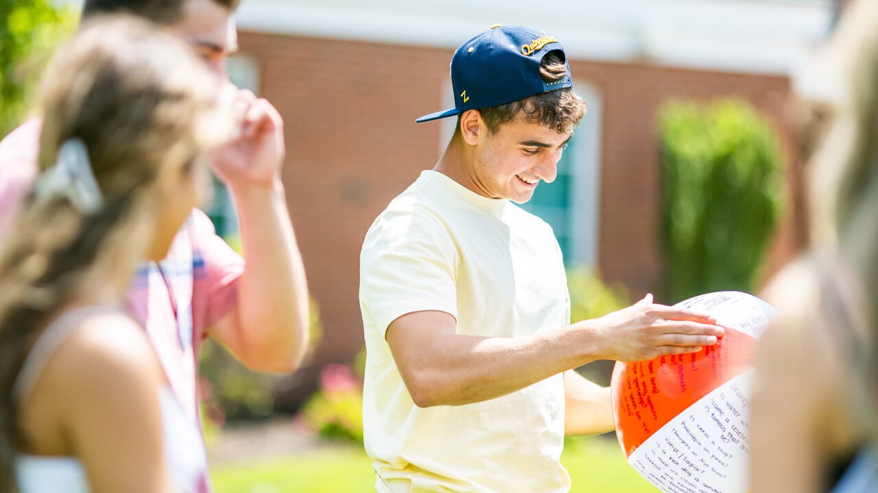 Student looks at beach ball