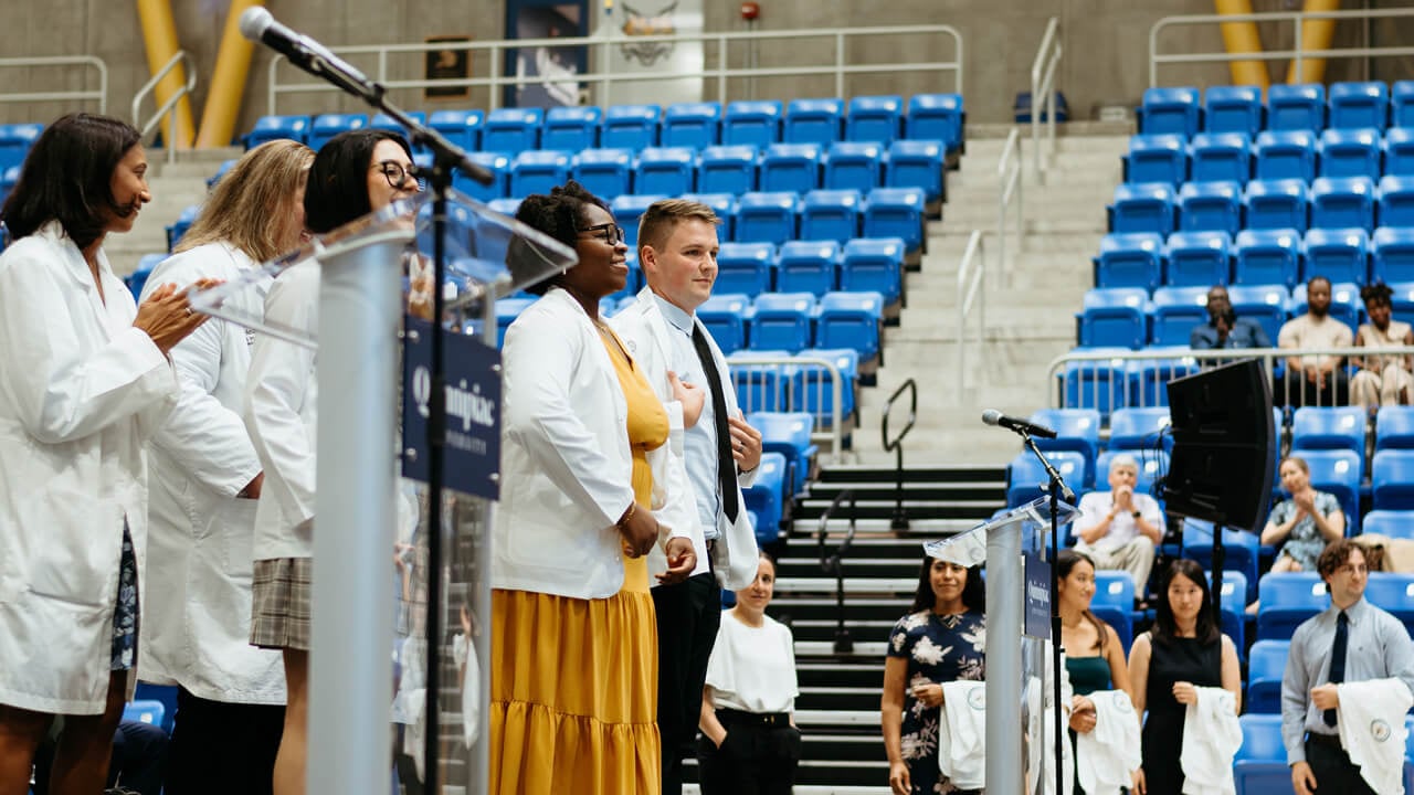 Students face the crowd while on stage