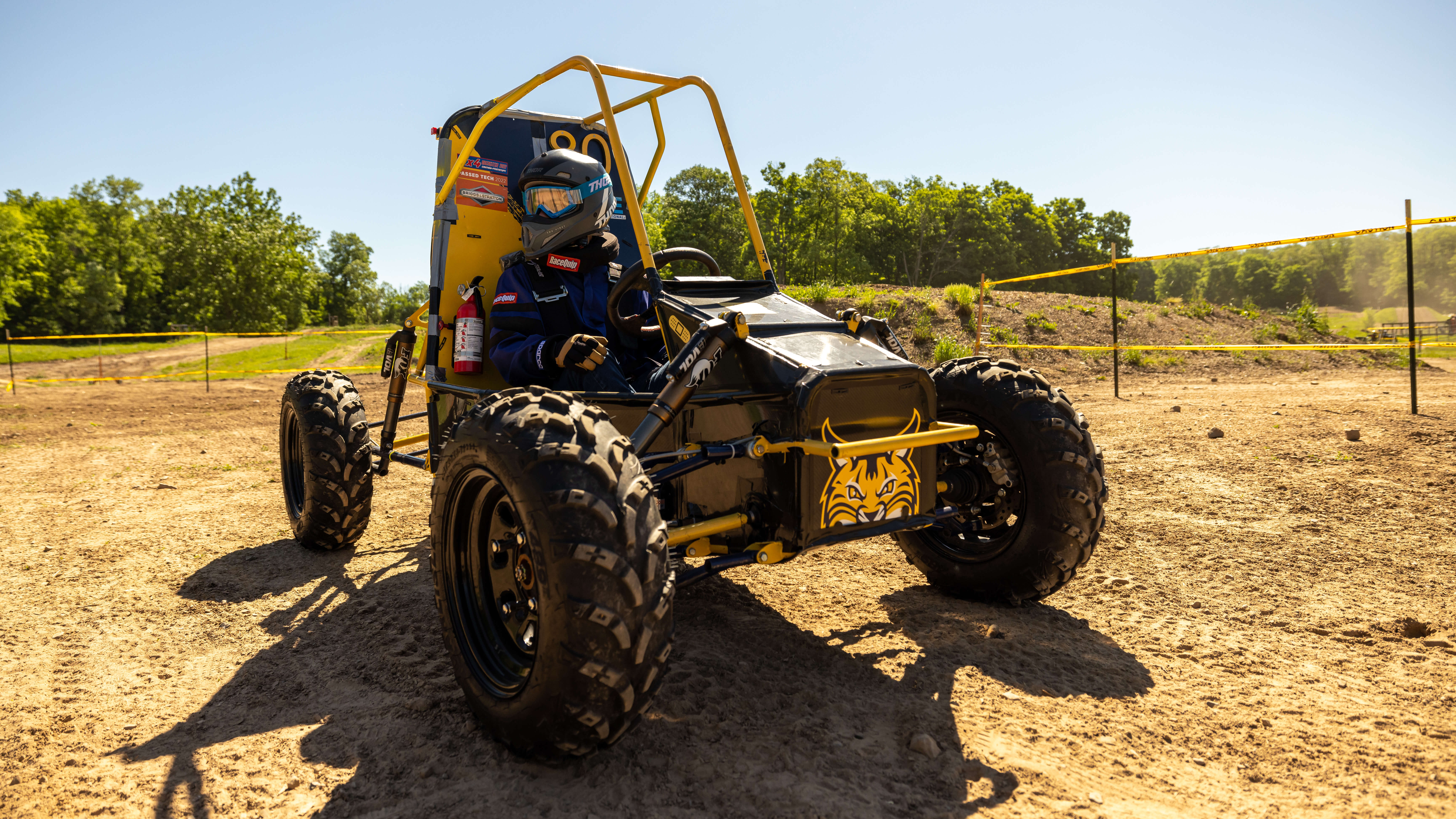 Student sits in a Quinnipiac vehicle