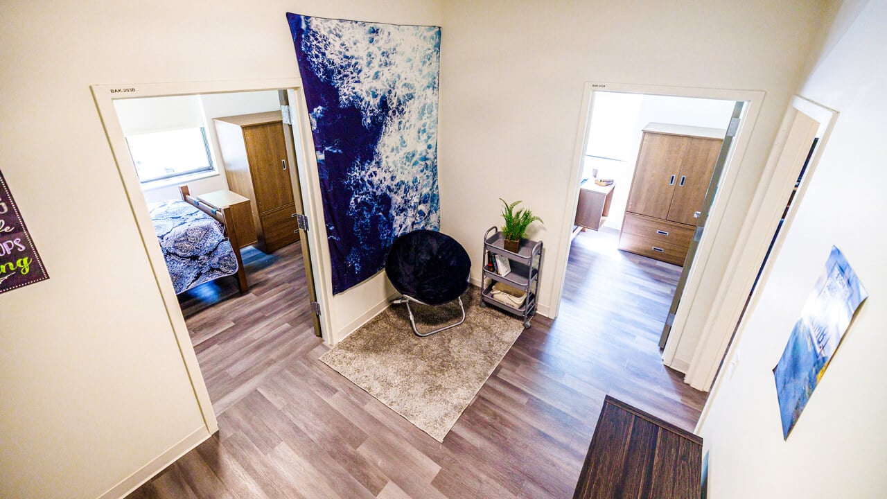 A reading corner in a hallway leading to bedrooms