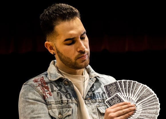 tj salta magician holding cards