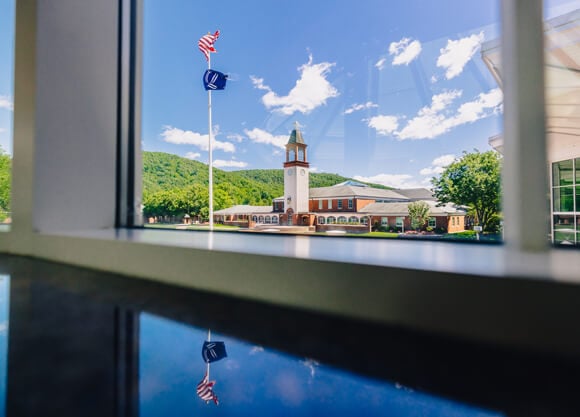 View of the Arnold Bernhard Library clocktower through a student center window