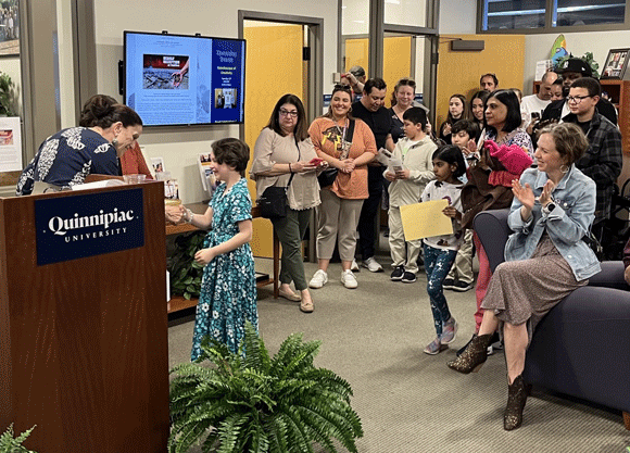 School of Education Dean Anne Dichele celebrates student artist at the gallery ceremony