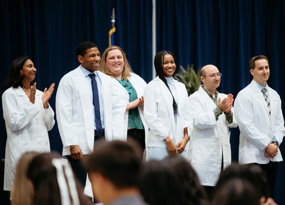 Students receive their white coats