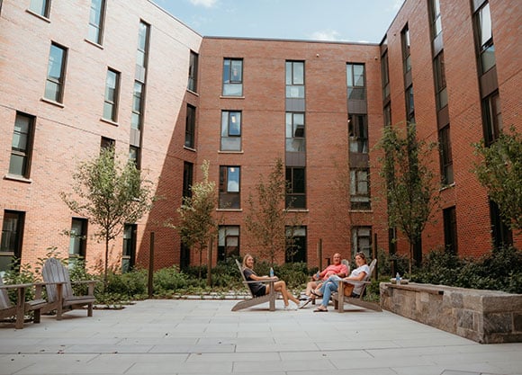 A family sits in The Grove courtyard.