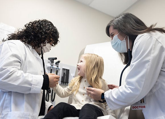 Doctors work with a patient.