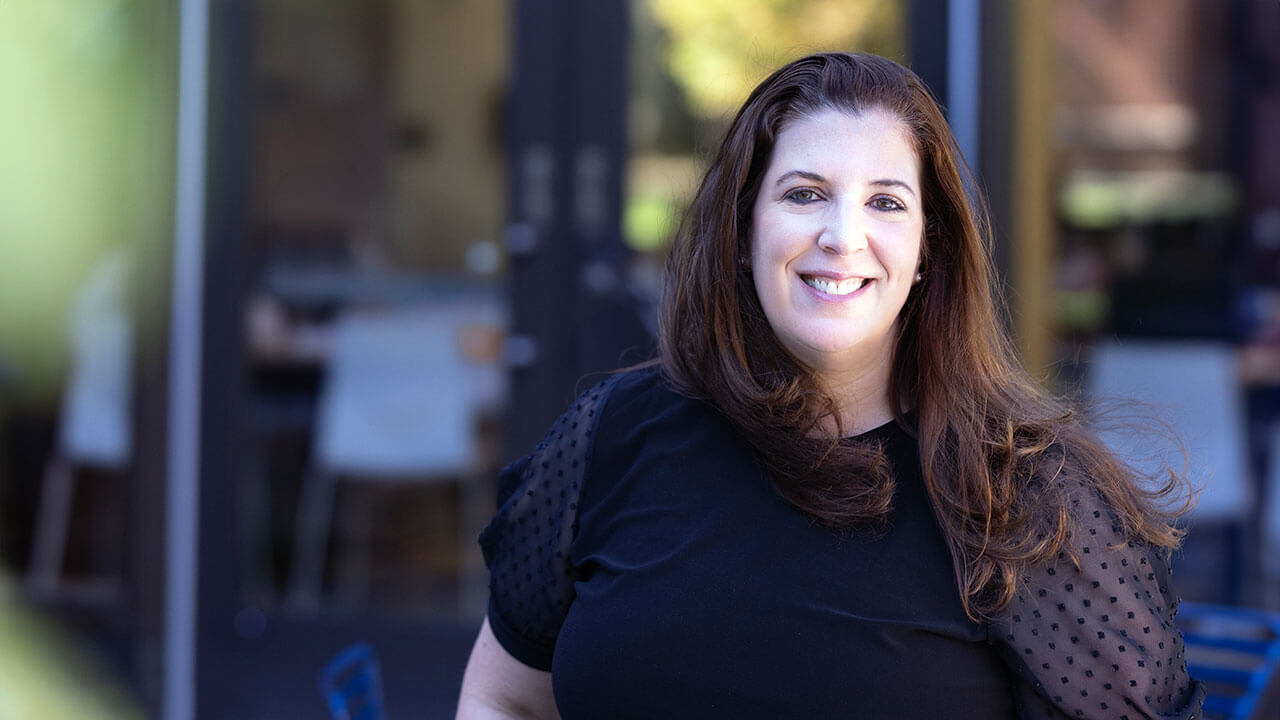 2023 Excellence in Teaching Award honoree Theresa Luersen poses outside.