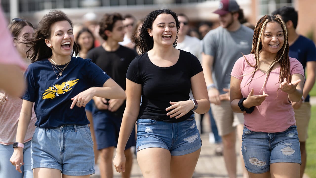 Student orientation leaders walk out of the Carl Hansen Student Center on the Mount Carmel Campus.