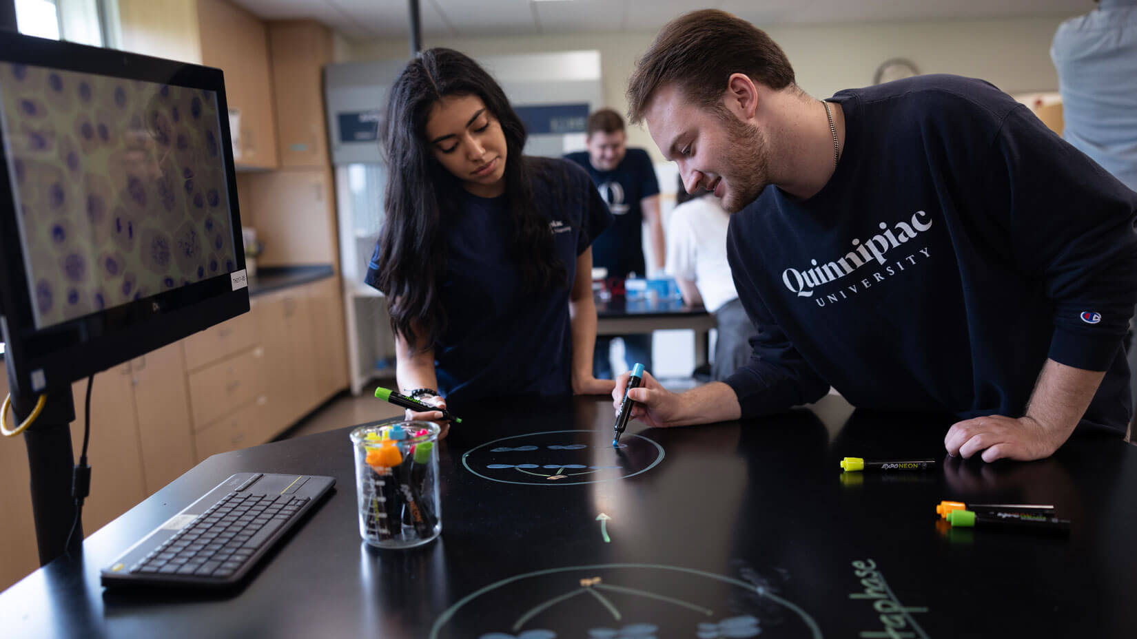 Students analyze a specimen during a lab exercise in class.