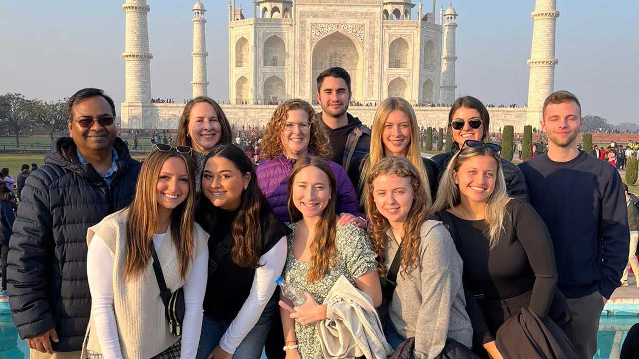 MBA students stand in front of the Taj Mahal in India.