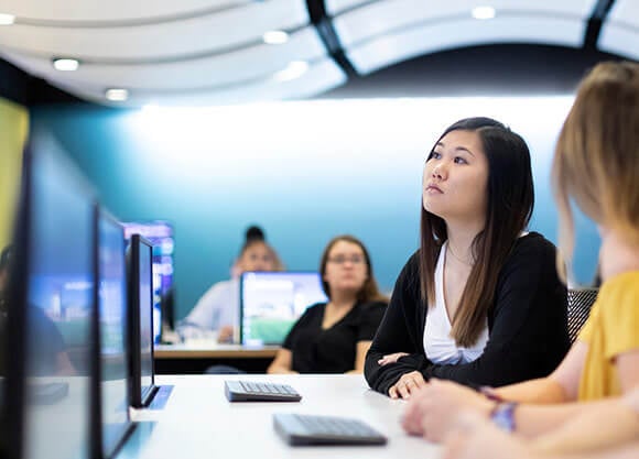 students at tables listening