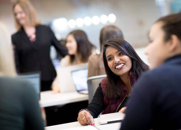 A student smiling in a classroom