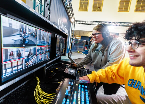 2 students looking at tv monitors