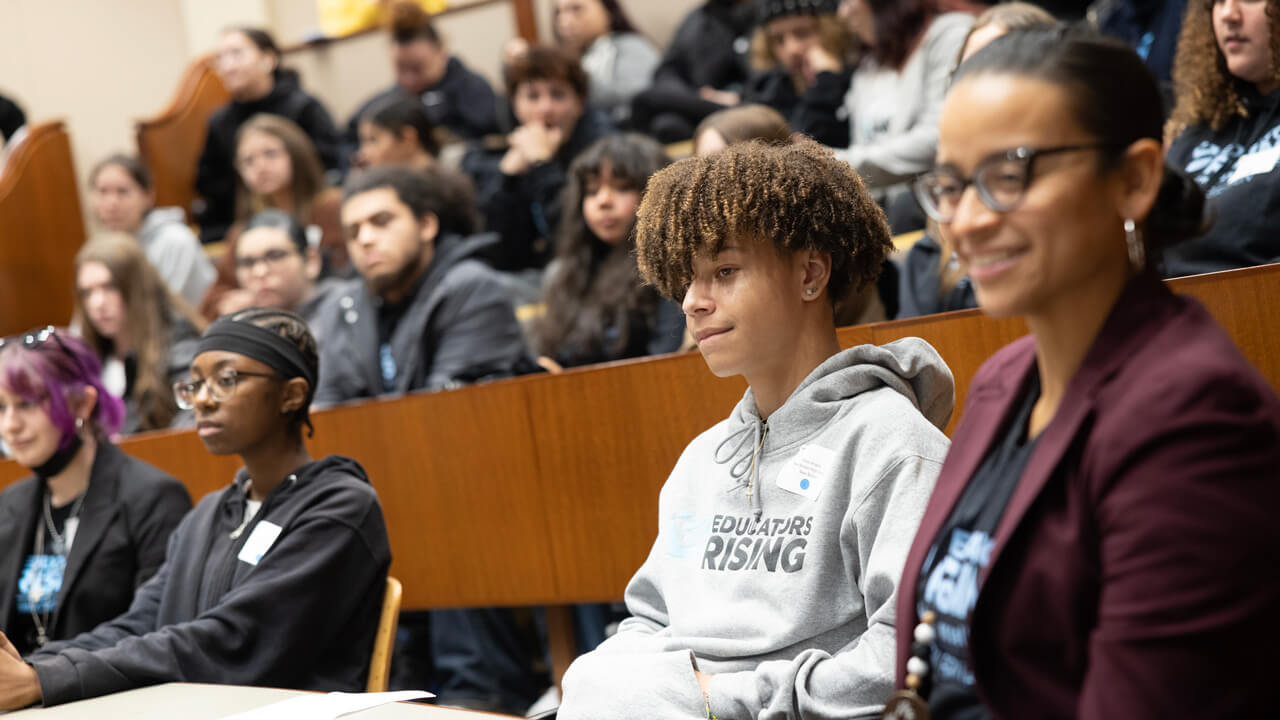 Students sit in on an education symposium