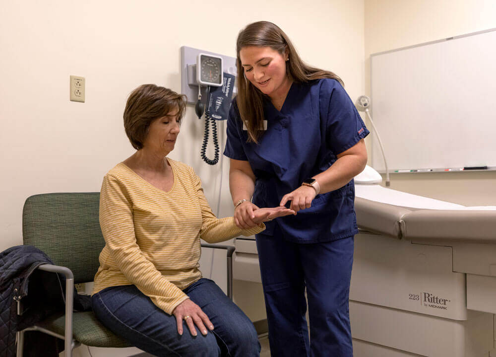 An occupational therapy student practices clinical skills in the standardized patient center