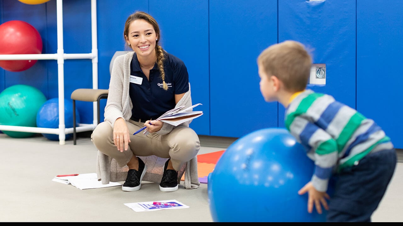 Quinnipiac University School of Health Sciences occupational therapy student Kaitlin Muehlberger interacts with toddler Steven Tilke during Baby Day Observation and Play in the Movement Lab at the North Haven Campus