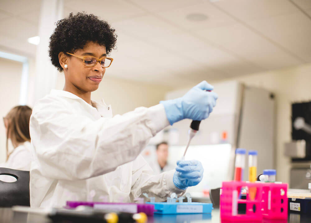 A student conducts a laboratory procedure in the Buckman Center Bio Lab