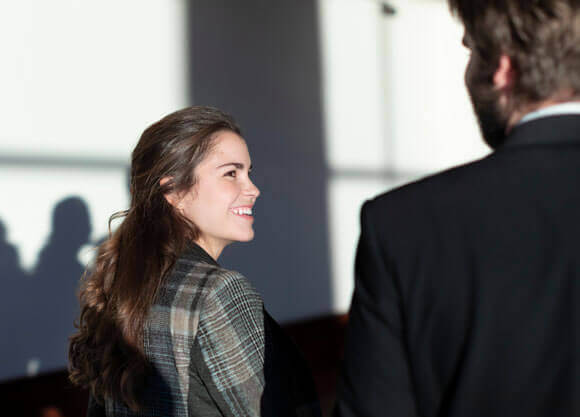 Two graduate students talk together outside